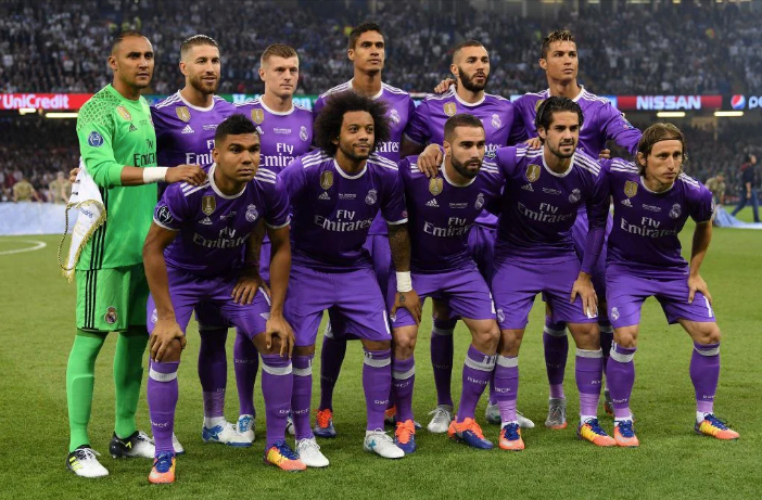 Real Madrid players lined up in purple jerseys before a match